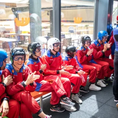 Grupo de flyers sonrientes y felices esperando para entrar al túnel de viento